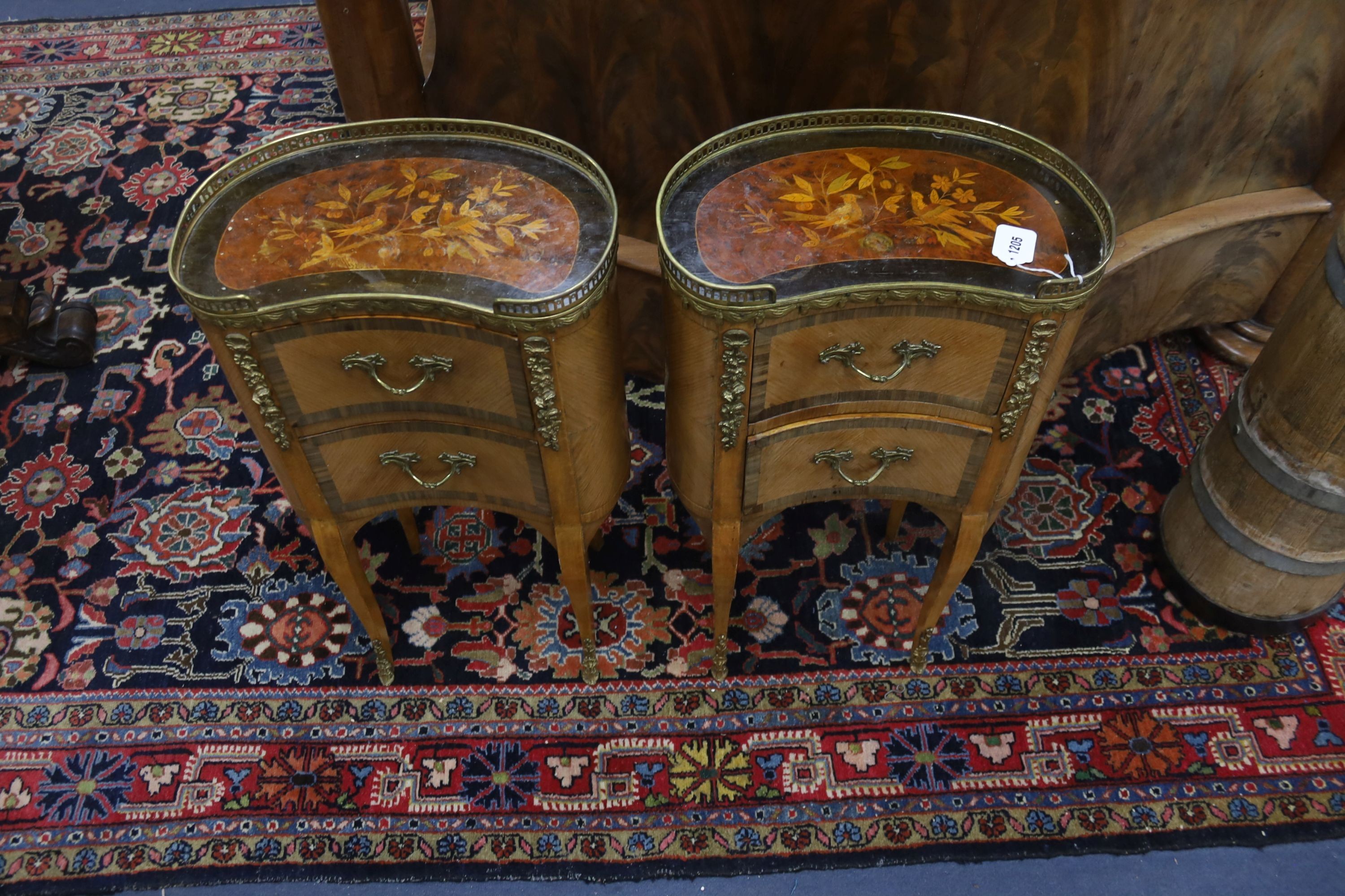A pair of French marquetry inlaid gilt metal mounted kidney shaped two drawer bedside cabinets, width 42cm, depth 24cm, height 77cm